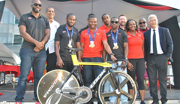 CELEBRATION TIME! Cyclist Nicholas Paul, the fastest man in the world, is surrounded by his national teammates Quincy Alexander, left, Kwesi Browne, 2nd from left, Port-of-Spain Mayor Joel Martinez, right, Antonia Berton, 2nd from right, and Keron Bramble. The team won a gold medal in the team sprint event, while Paul set a new world record in the flying 200meters event at the just concluded Elite Pan American Continental Championship in Bolivia and was celebrated on the Brian Lara Promenade in the Capital City on Saturday.