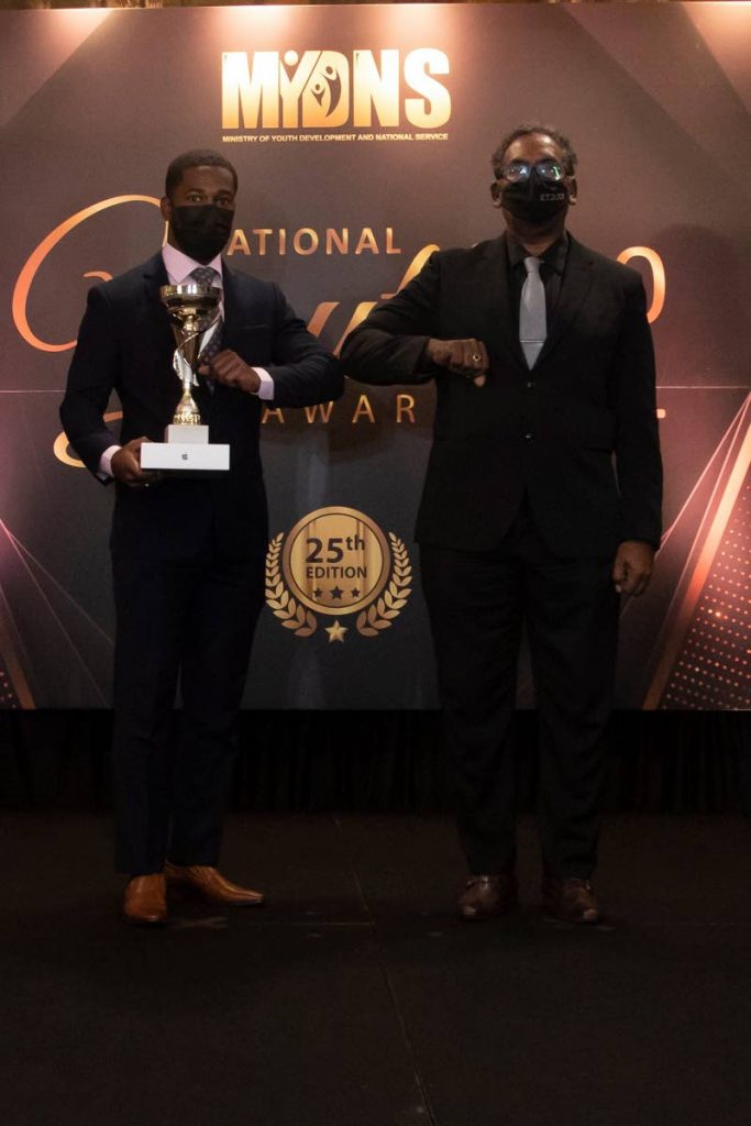 Olympic cyclist Kwesi Browne, left, with his National Youth Award for Community Sport (18-35). - Ministry of Youth Development and National Service