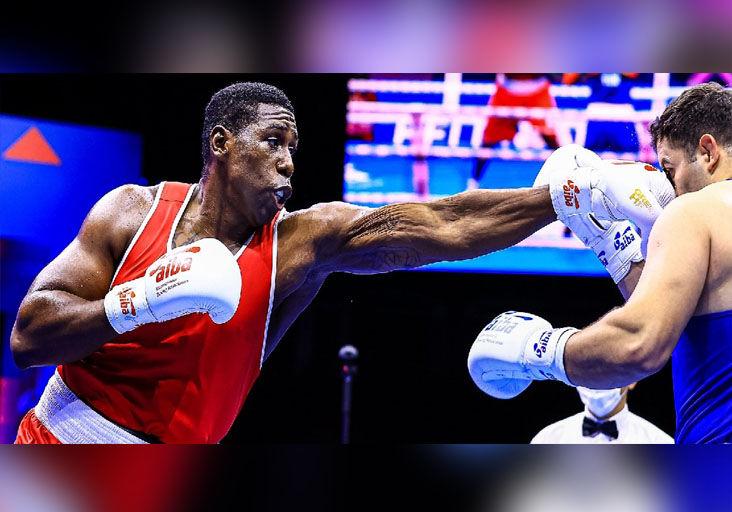 TAKE THAT: Trinidad and Tobago’s  super-heavyweight Nigel Paul lands a straight left flush to the face of Turkey’s Berat Acar during their quarter-final clash at the 2021 AIBA World Boxing Championships in Belgrade, Serbia, yesterday. Paul won the encounter 4-1 to advance to the medal round. —Photo courtesy AIBA