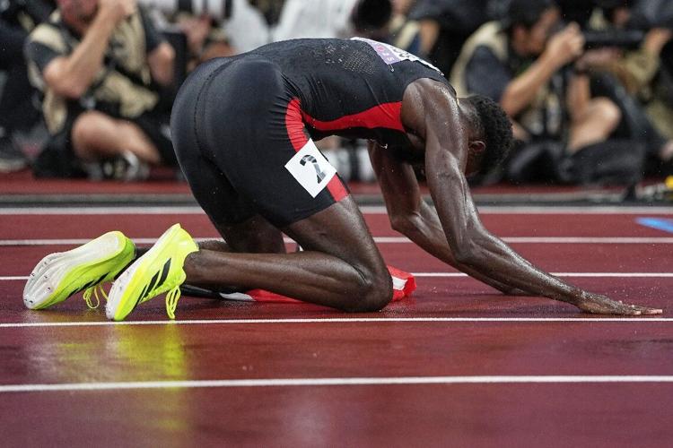 GRATEFUL: T&T sprinter Jereem “The Dream” Richards kneels down on the track after capturing the silver medal in the Men’s 400 metres at the World Athletics Championships in Tokyo, Japan, in September. —Photos: AP (Image obtained at trinidadexpress.com)