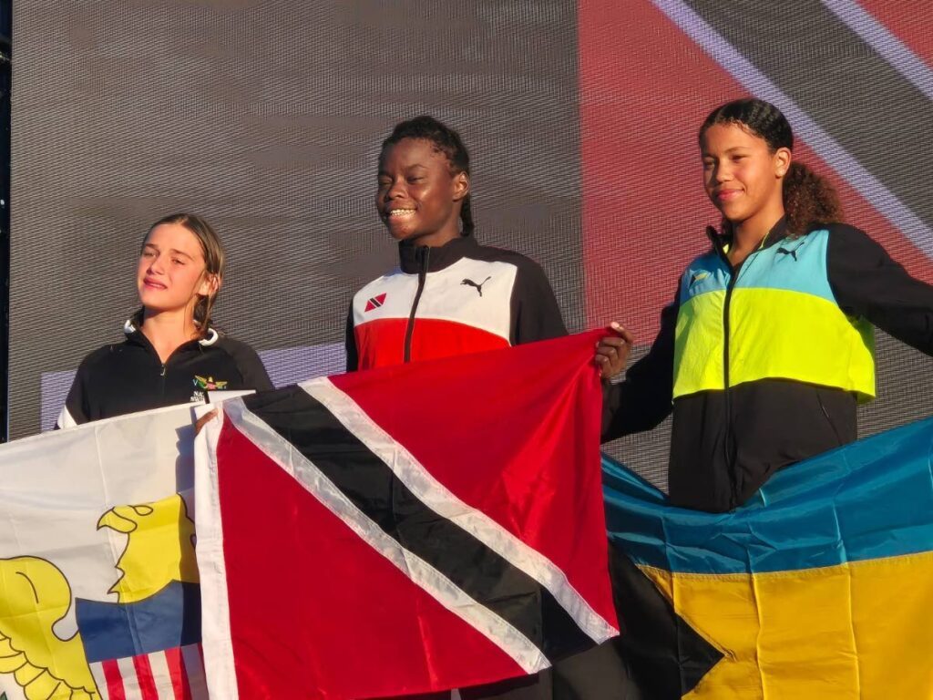 Zara Persico of TT, middle, after winning gold in the girls 11-12 200m freestyle event at the Carifta Swimming Aquatic Championships, held at the Betty Kelly-Kenning Aquatic Centre, Bahamas. - (Image obtained at newsday.co.tt)
